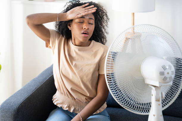 Black woman at home refreshing during summer haze