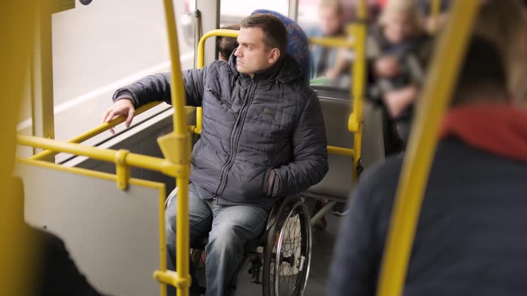 Person with a physical disability enters public transport with an accessible ramp