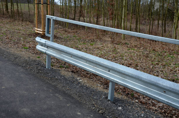 istock path for cyclists with an asphalt surface. galvanized iron railing over road barriers. Bridge railing with tilting to the sides. railing made of perforated sheet metal in the shape of a triangle 1390086145