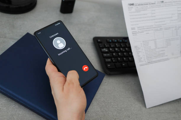 istock Phone call from unknown number.  Man answering to incoming call. 1390092080