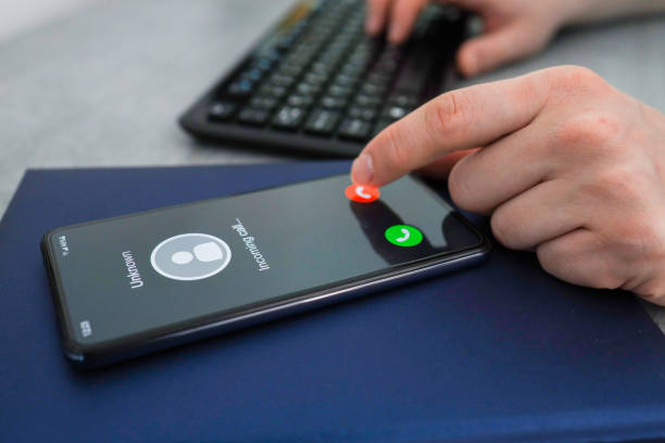 istock Unknown caller. A man thinks to end the call. Incoming call from an unknown number. 1390092201