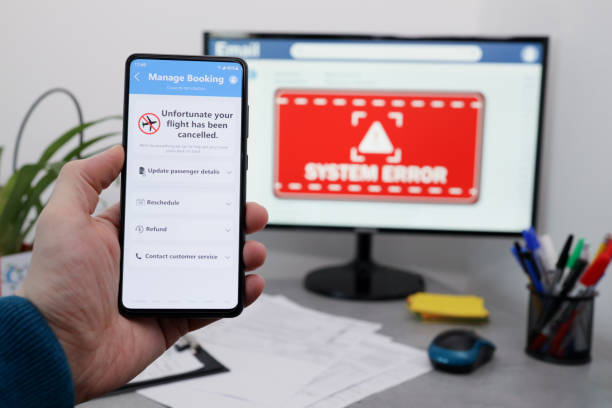 istock Flight cancelled. Smartphone application announces that flight is cancelled. Man holding mobile phone in office. 1390092901
