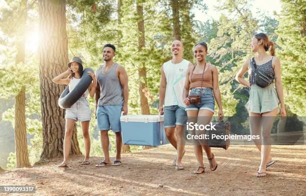 Full Length Shot Of A Diverse Group Of Friends Enjoying A Day Out In The Woods Stock Photo - Download Image Now