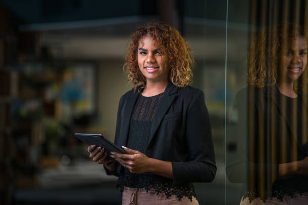 istock Latin Non Binary Business Person Using A Digital Tablet 1390094386