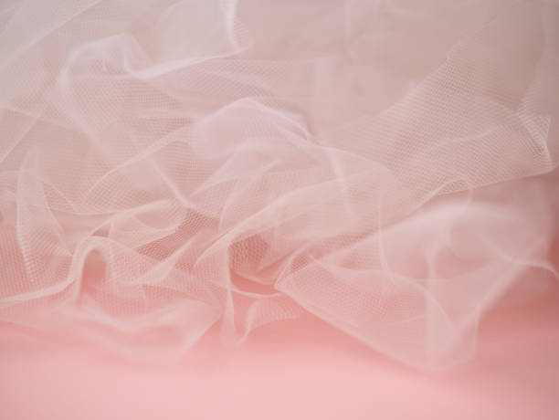 istock Abstract texture of white tulle on a pink background 1390094406