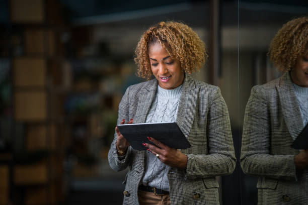 istock Hispanic Business Woman in 40s Using a Digital Tablet 1390094415