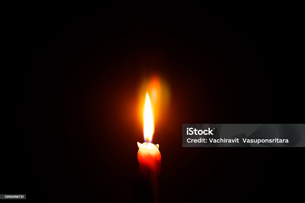 light a candle in a dark room Flame Stock Photo