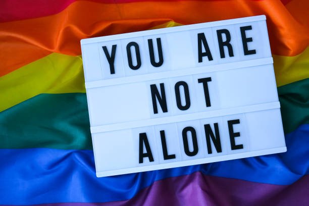 istock Rainbow flag with lightbox and text YOU ARE NOT ALONE. Rainbow lgbtq flag made from silk material. Symbol of LGBTQ pride month. Equal rights. Peace and freedom 1390098825