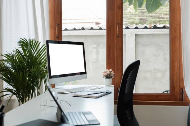 istock Wooden work desk with pc computer with blank screen and documents, books, modern interior of cozy cabinet, table for businessman or student at home, comfortable workspace, workplace with computer in apartment. 1390100276