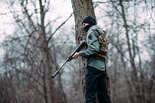 The hunter prepares the rifle