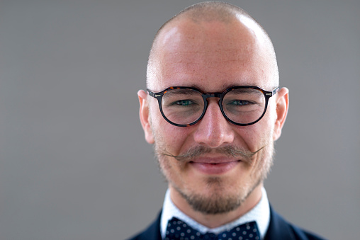 Hipster styled portrait a young man, studioshot with tilt shift lens