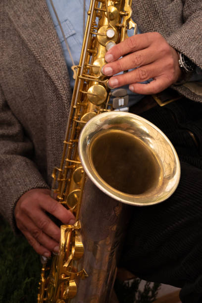 istock Close-up of a saxophone. Hands playing a saxophone. Musical instruments 1390104566