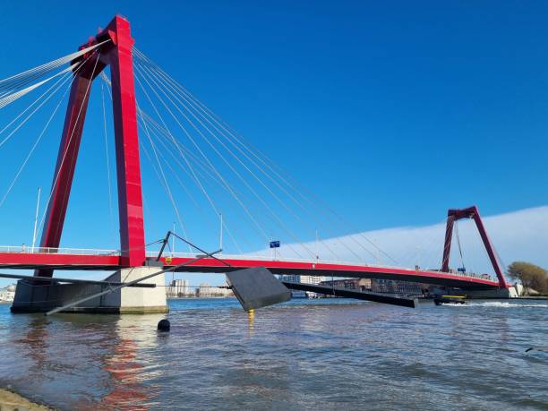 istock Bright red Willemsbrug bridge over the river Meuse with blue sky 1390104937