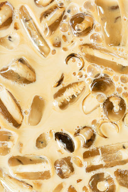 istock Coffee and ice texture,Close-up of Cold latte drink with ice cubes, 1390104941