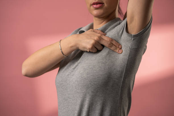 Woman doing breast cancer self exam stock photo