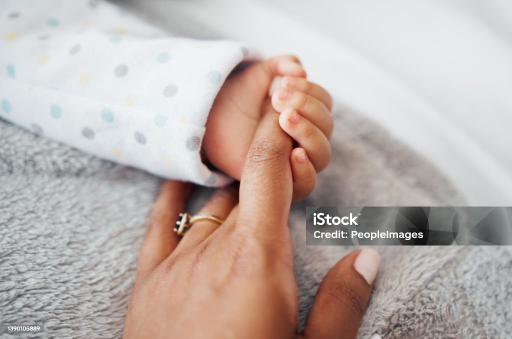 Shot of a mother holding her baby's hand I'll never let you go Baby - Human Age Stock Photo