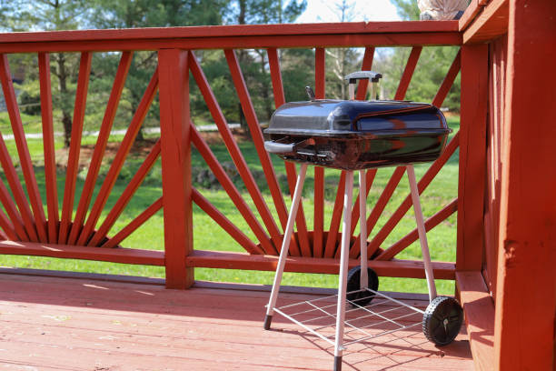 istock A black charcoal grill sitting on a patio deck 1390106070
