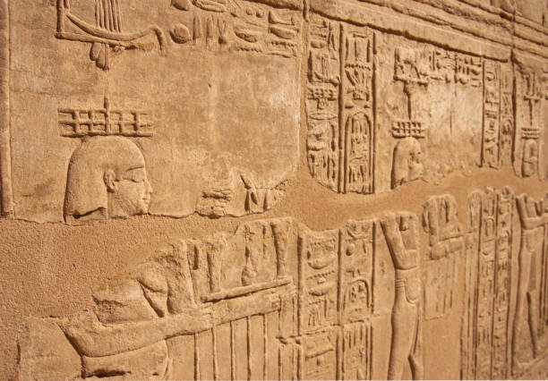 istock Ancient Egyptian murals hieroglyphs on stone wall in Karnak temple Luxor, Egypt. 1390106311