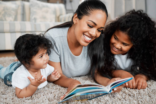 istock Shot of a mother reading to her daughters 1390106521