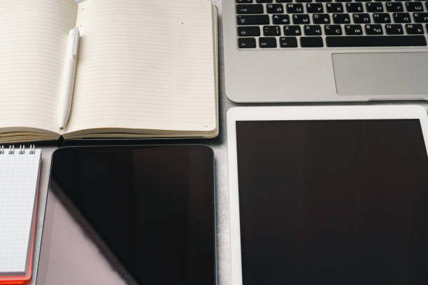Digital tablet with empty screen on table with business accessories, close up