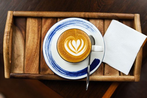 Latte coffee in a white cup Heart shaped latte art