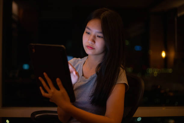 istock Asian woman using an iPad on her desk 1390109126