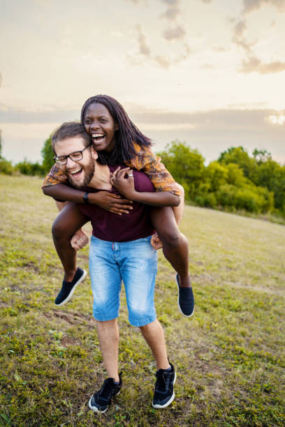 istock Happy multiethnic couple having fun time in the nature 1390109225