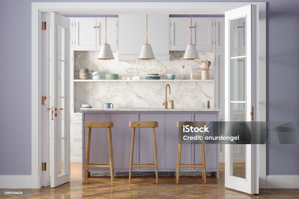 Entrance Of Modern Kitchen With White Cabinets, Kitchen Island, Pendant Lights, Wooden Stools And Purple Wall In Background Purple Stock Photo
