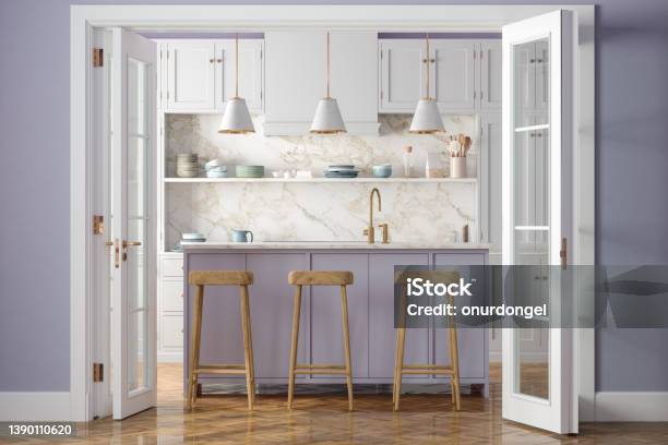 Entrance Of Modern Kitchen With White Cabinets Kitchen Island Pendant Lights Wooden Stools And Purple Wall In Background Stock Photo - Download Image Now