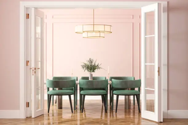 Photo of Entrance Of Dining Room With Dining Table, Green Velvet Chairs And Pink Wall In Background