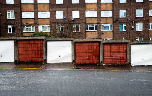 Rows of garages and tenement blocks on a council estate in the north of England A social housing or council house estate in a town in the north of England during the UK governments levelling up policies doncaster photos stock pictures, royalty-free photos & images