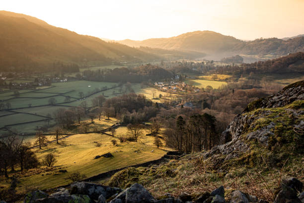 Aerial Landscape of Grasmere village in the lake District National Park An early morning aerial landscape view of Grasmere village in the Lake District Nation Park with shafts of sunlight and copy space in grasmere stock pictures, royalty-free photos & images