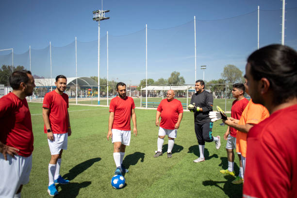 istock Friends playing soccer 1390114180