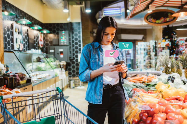 istock Young brunette woman looking at mobile phone 1390114972
