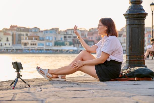 istock Woman recording stream on a smartphone on a tripod. 1390115694