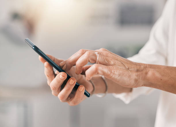 istock Cropped shot of an unrecognizable businesswoman using her cellphone at work 1390116885