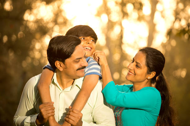 istock Happy family having fun at park 1390117952