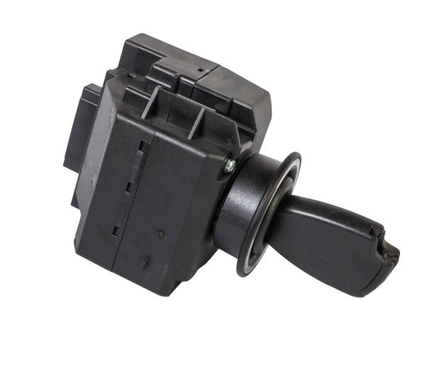 Electronic ignition lock made of metal with a key and a button made of black plastic on a white isolated background in a photography studio, a spare part for car repair or for sale in junk yard. cerradura de encendido electrónico de metal con una llave y un botón de plástico negro sobre un fondo blanco aislado en un estudio de fotografía, una pieza de repuesto para la reparación de automóviles o para la venta en un depósito de chatarra