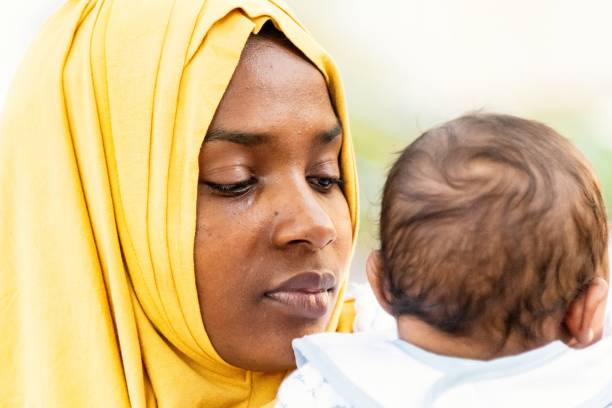 istock Black Muslim mother holding her baby 1390119492