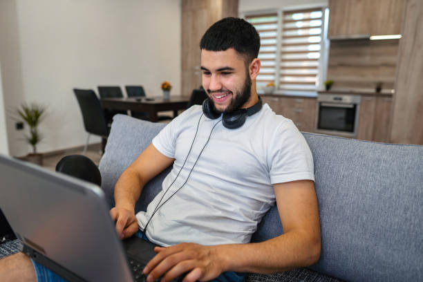istock Young man working on laptop from his home and hanging out with his dog pet 1390120249