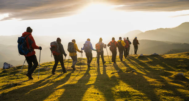 istock Silhouettes Of Hikers At Sunset 1390120388