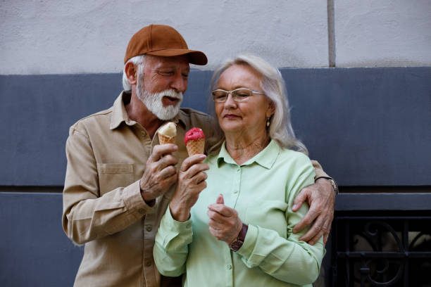 istock Senior couple holding ice creams 1390120563