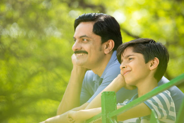 istock Happy father and son admiring view at park 1390120651