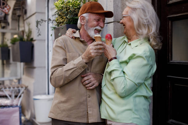 istock Senior couple tourists having a fun with ice cream 1390120677