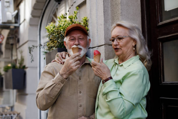 istock Hugging senior couple holding ice cream 1390120736