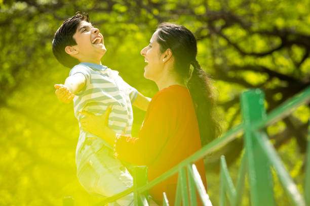 istock Carefree mother and son having fun at park 1390120940