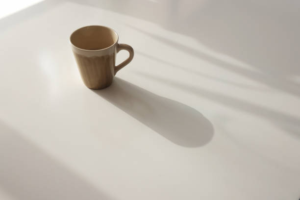Coffee cup on table photo taken in natural sunlight