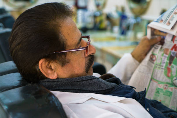 istock Shot of an elderly man reading a newspaper 1390130119