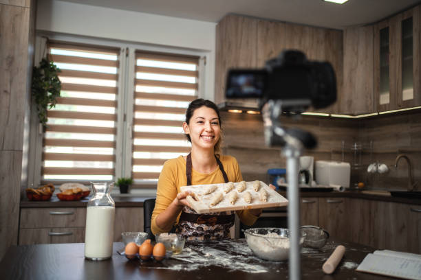 istock Young woman making a video about kneading fresh pastries in her home kitchen 1390130502