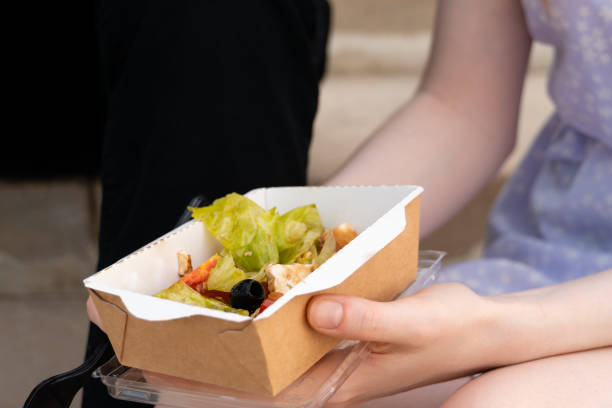 istock Crop female holding container with takeaway food. 1390131274